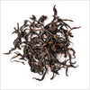 Pile of loose leaf Ai Lao Wild Black tea to show wiry deep brown loose leaf tea.