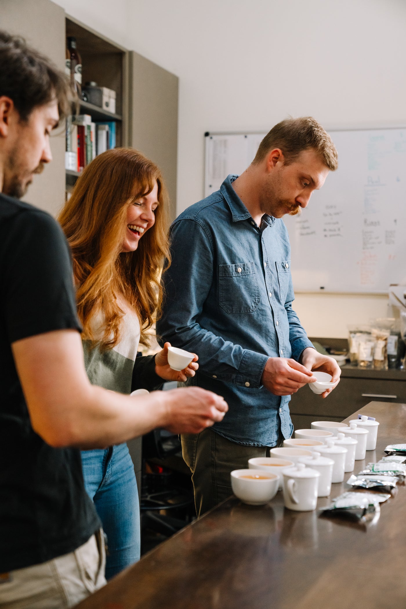 Three teamakers tasting Darjeeling teas in the Smith Teamaker lab.