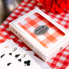 Deck of Smith Teamaker playing cards with red and white gingham pattern and Smith Teamaker logo.